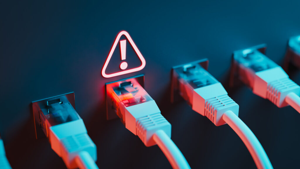 Network cables plugged into Ethernet ports with one port highlighted in red and a warning symbol indicating a connectivity issue