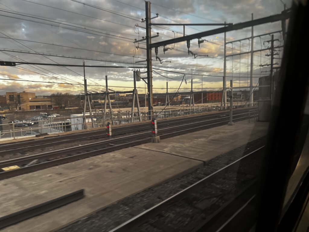 View from an Amtrak train window approaching Boston at sunrise