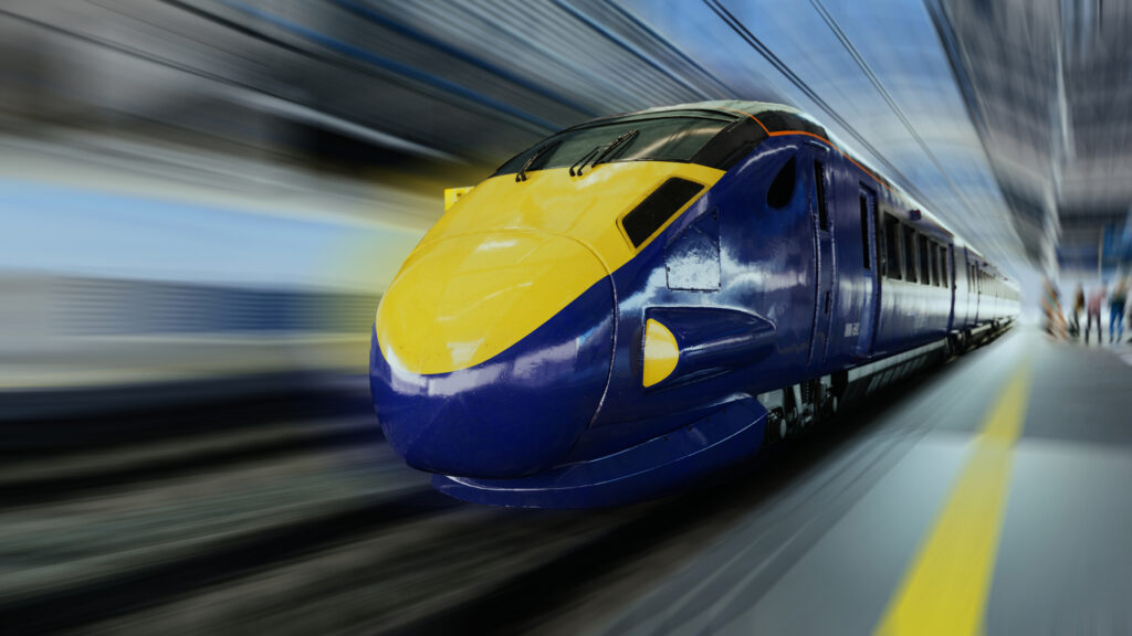 Modern high-speed bullet train in motion, captured at a station with motion blur to emphasize speed and technology