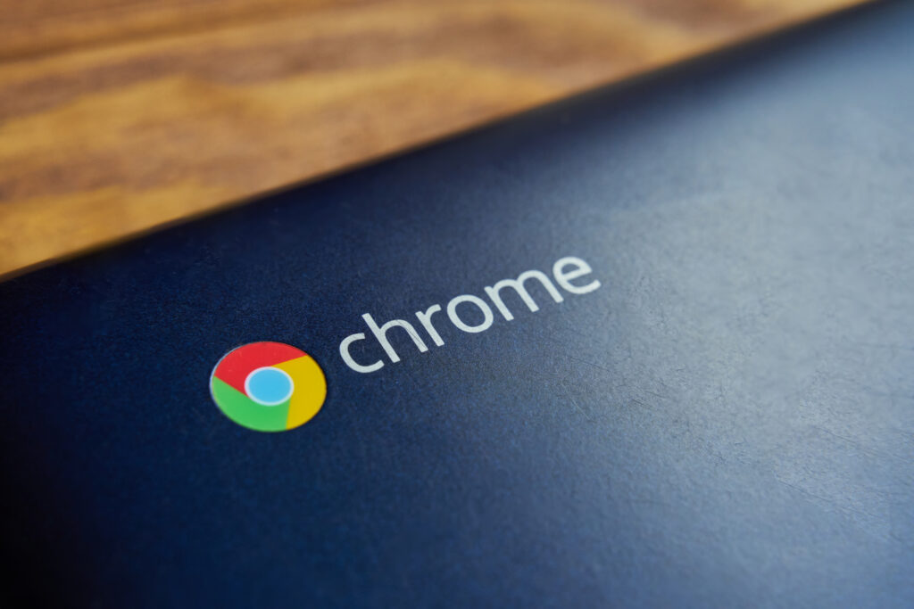 Close-up of Chromebook logo on a dark blue laptop, symbolizing setup and configuration