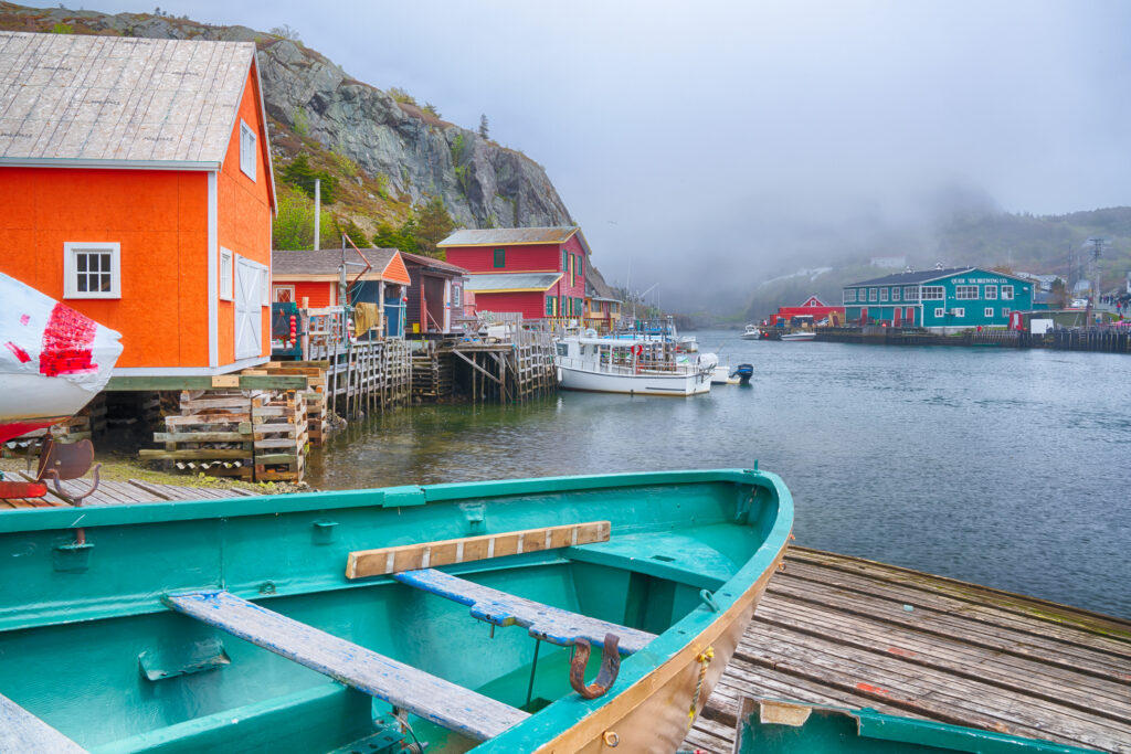 Colorful fishing stages and boats in Quidi Vidi, a historic fishing village near St. John's, Newfoundland, on a foggy day