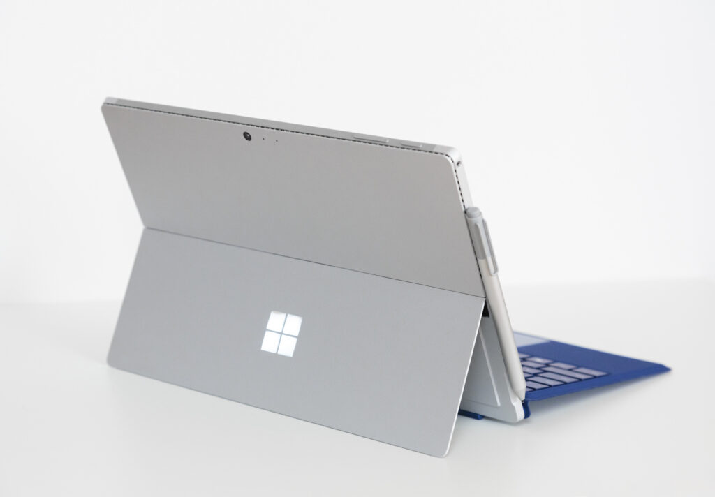 Microsoft Surface Pro with kickstand open, detachable keyboard, and Surface Pen attached.